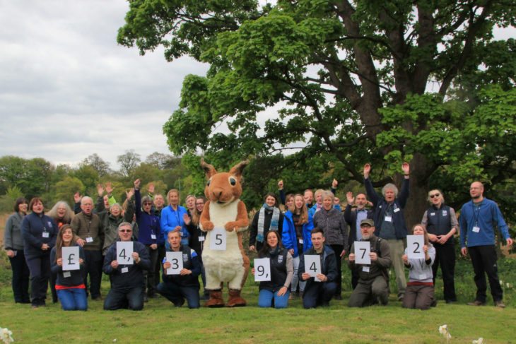 Staff and volunteers celebrate a funding milestone