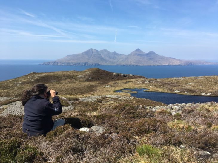 Scottish Wildlife Trust Ranger Norah Barnes during a monitoring day on the Isle of Eigg. The Isle of Rhum is in the background. © Érika Faggiani