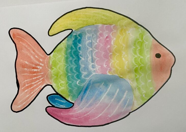 A fish painted in multiple colours with white wax pattern coming through.