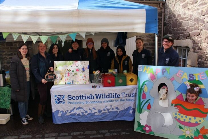 Scottish Wildlife Trust Young Leaders under a gazebo at the Falls of Clyde Visitor Centre.