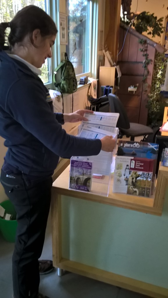 Melissa checking out the bus timetables ©Scottish Wildlife Trust/Jonathan Pinnick